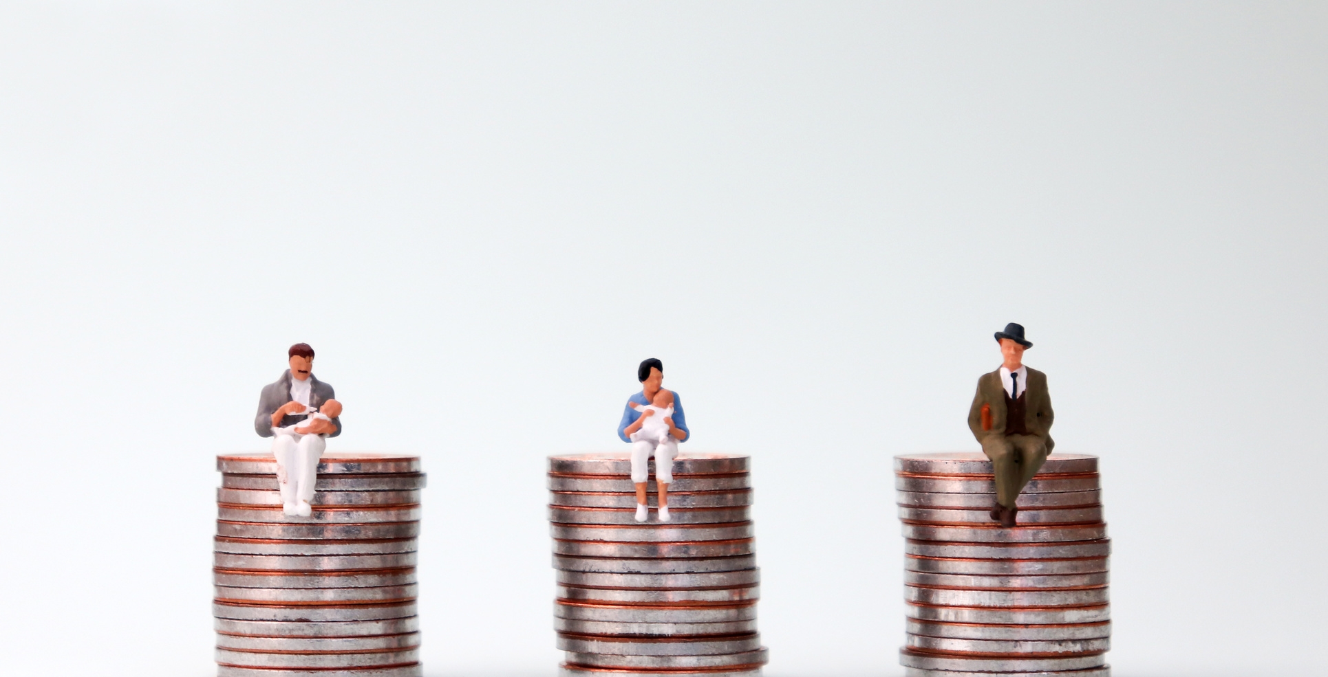 An equal pay concept. Miniature people sitting in the same height pile of coins. Geldmünzen