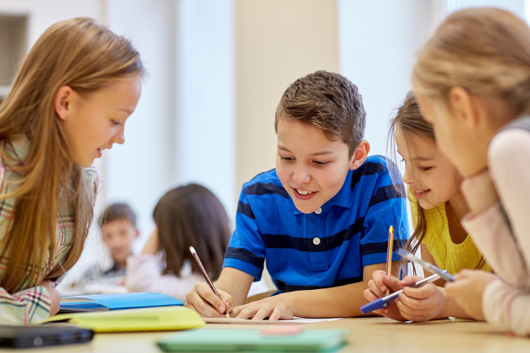 group of students talking and writing at school Schulkinder