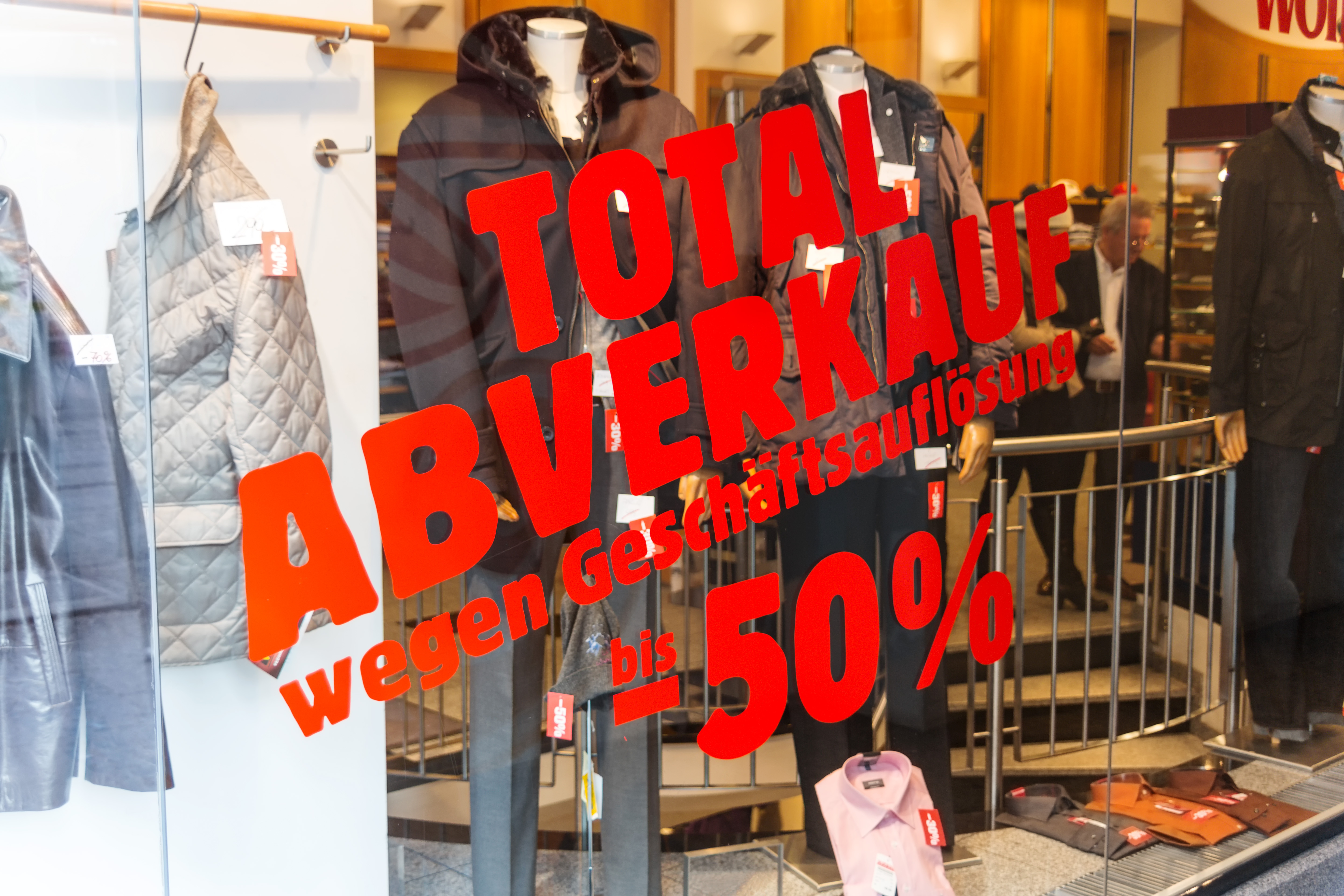 Aufschrift auf Schaufensterscheibe: Totalabverkauf wegen Geschäftsaufgabe -50%
